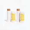 Ollie Kit TBD with two tinted sunscreen sticks SPF 95 in medium shades, ideal for natural coverage and daily sun protection